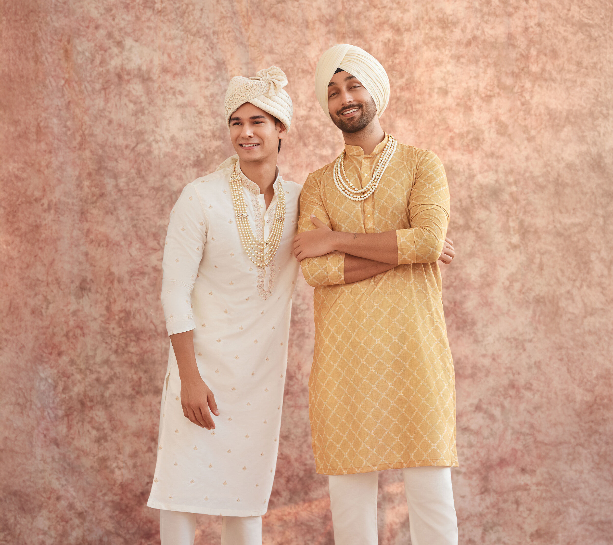 Traditional men&rsquo;s wedding styling with embroidered kurta sets, turbans, and pearl malas